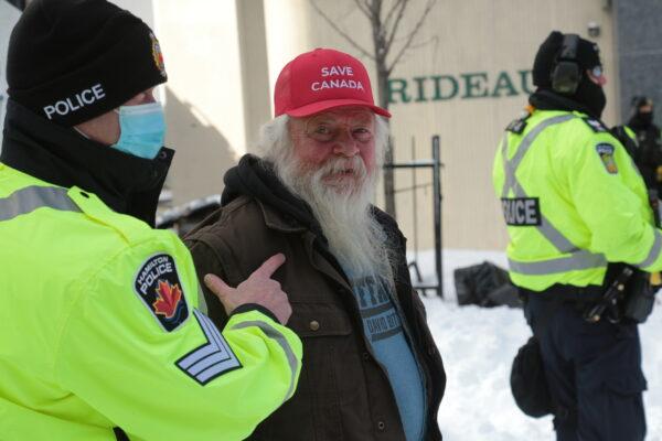 A trucker is arrested in Ottawa on Feb. 18, 2022. (Richard Moore/The Epoch Times)