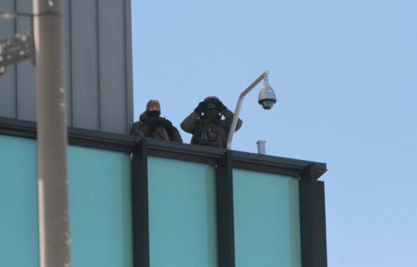 Police spotters on a high point observe the crowd in Ottawa on Feb. 18, 2022. (Richard Moore/The Epoch Times)