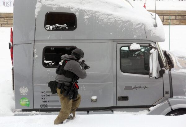 A police officer approaches a truck as police deploy to remove protesters in Ottawa on Feb. 19, 2022. (Dave Chan/AFP via Getty Images)