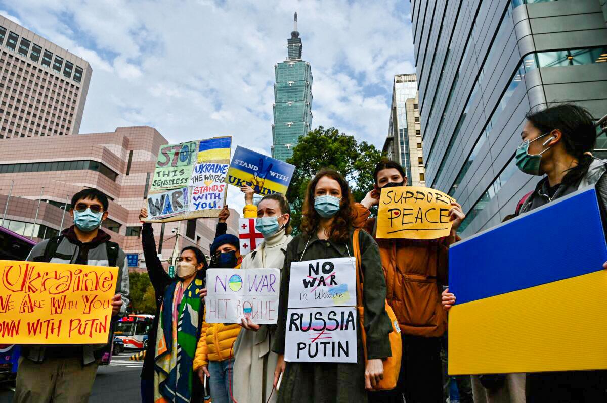 A group of Slavic people living in Taiwan display placards to protest against Russia's military invasion of Ukraine, in Taipei on Feb. 25, 2022. (Sam Yeh/AFP via Getty Images)