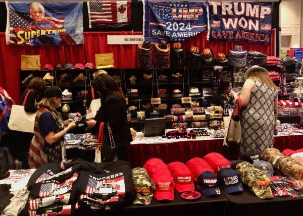 Shoppers look over a plethora of Trump gear at CPAC 2022 in Orlando, Fla., on Feb. 25, 2022. (Nanette Holt/The Epoch Times)