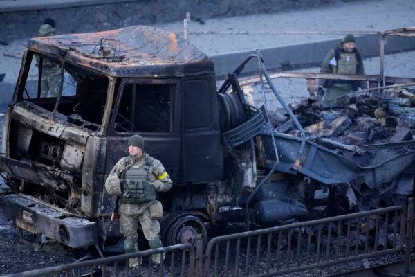 Ukrainian troops inspect a site following a Russian airstrike in Kyiv, Ukraine, on Feb. 26, 2022. (AP Photo/Vadim Ghirda)