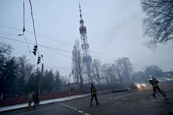 A fireman runs after a Russian airstrike hit Kyiv's main television tower in Kyiv, Ukraine, on March 1, 2022. (Sergei Supinsky/AFP via Getty Images)
