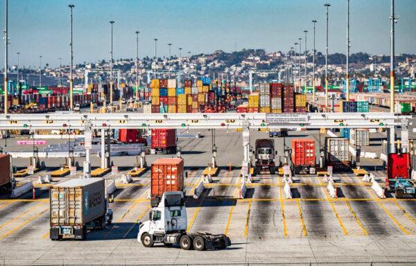 Trucks loaded with shipping containers prepare to leave the Port of Long Beach, Calif., on Oct 27, 2021. (John Fredricks/The Epoch Times)