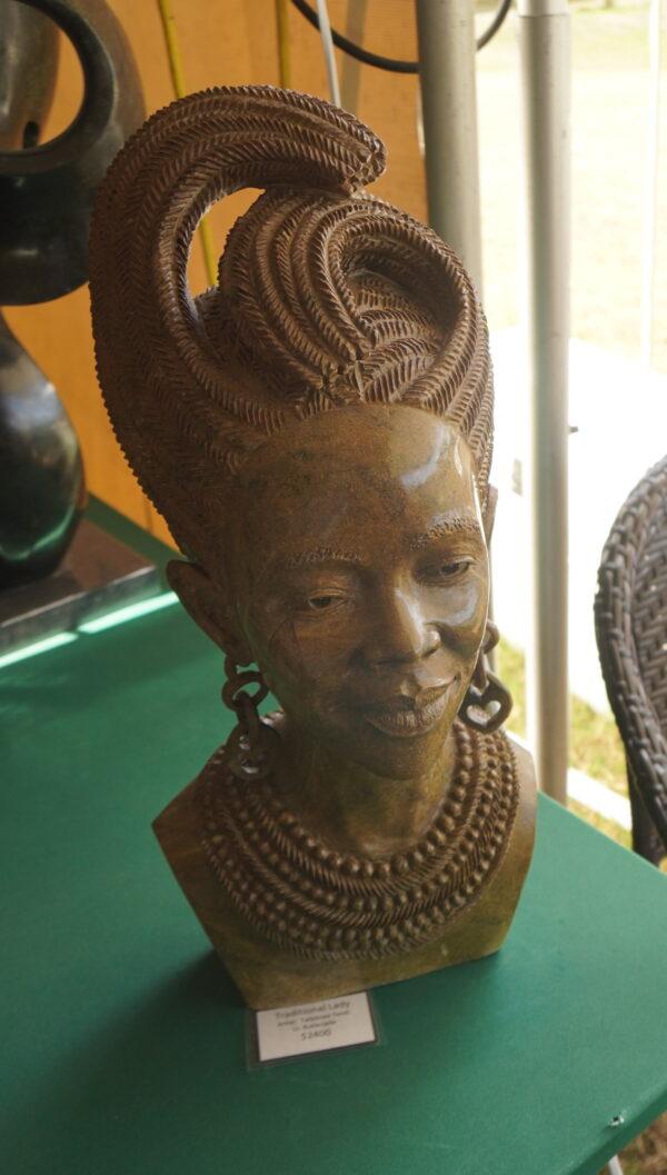 "Traditional Lady" by ZimSculpt's Farai Tandi carved in Butter Jade is on display in Punta Gorda, Fla., Feb. 24, 2022. (Jann Falkenstern/The Epoch Times)