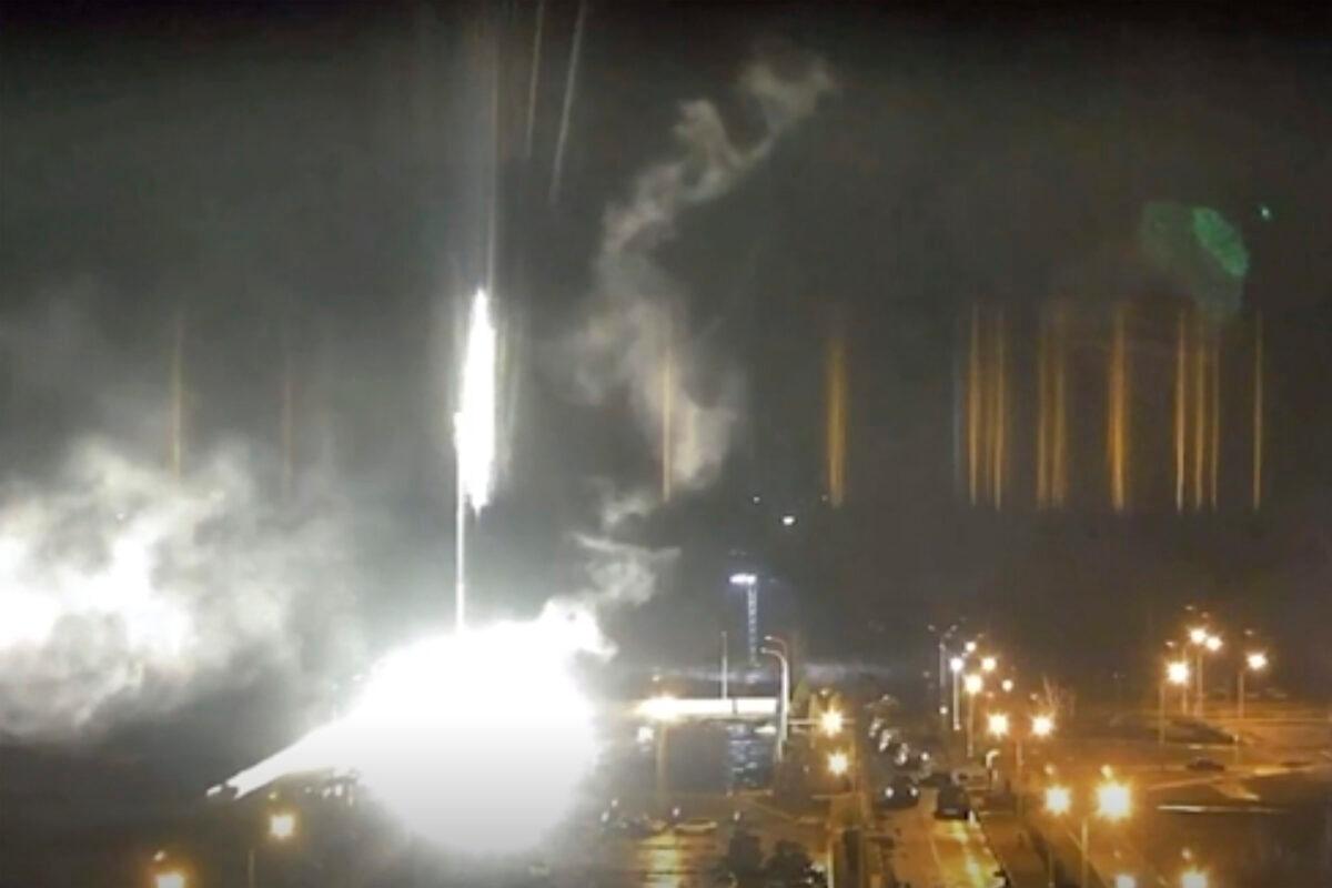 This image made from a video released by Zaporizhzhia nuclear power plant shows bright flaring objects landing on the grounds of the nuclear plant in Enerhodar, Ukraine Friday, March 4, 2022. (Zaporizhzhia nuclear power plant via AP)