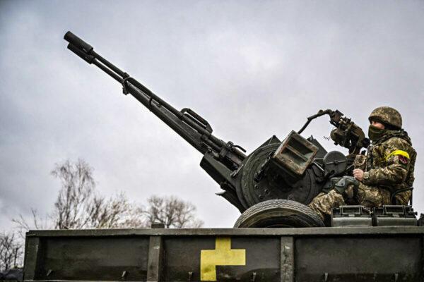 A Ukrainian soldier keeps position sitting on a ZU-23-2 anti-aircraft gun at a frontline, northeast of Kyiv, Ukraine, on March 3, 2022. (Aris Messinis/AFP via Getty Images)