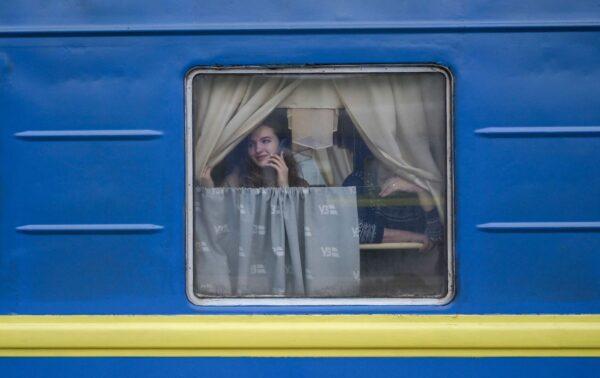 A woman in an evacuation train looks at her partner staying on the platform at the central train station in Odesa on March 6, 2022. (Bulent Kilic/AFP via Getty Images)