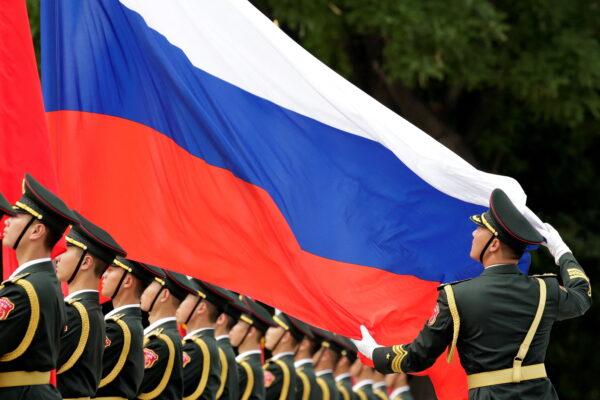 An honor guard holds a Russian flag during preparations for a welcome ceremony for Russian President Vladimir Putin outside the Great Hall of the People in Beijing, China, on June 8, 2018. (Jason Lee/Reuters)