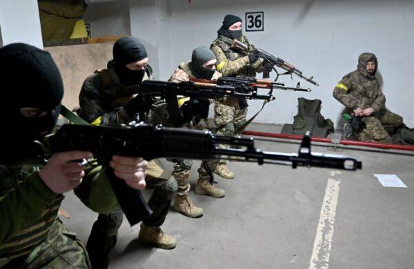 Soldiers of the Territorial Defense Forces of Ukraine, the military reserve of the Armed Forces of Ukraine, take part in military training in an underground garage that has been converted into a training and logistics base in Kyiv, Ukraine, on March 11, 2022. (Sergei Supinsky/AFP via Getty Images)