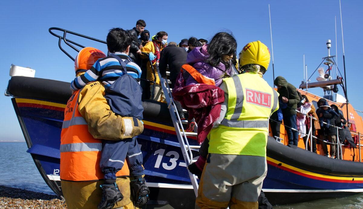 A group of people thought to be illegal immigrants are brought in to Dungeness, Kent, England, by the RNLI following a small boat incident in the English Channel on March 15, 2022. (Gareth Fuller/PA)