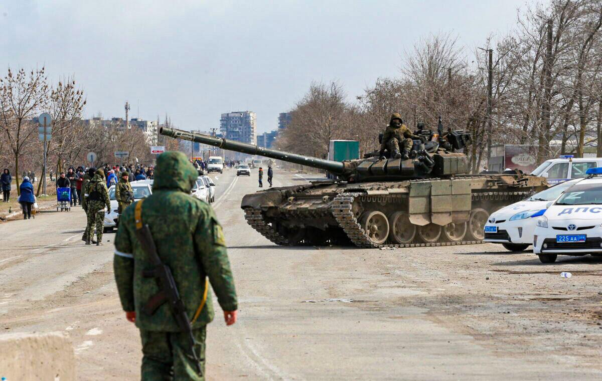 Service members of pro-Russian troops are seen atop a tank during the Ukraine-Russia conflict on the outskirts of the besieged southern port city of Mariupol, Ukraine, on March 20, 2022. (Alexander Ermochenko/Reuters)