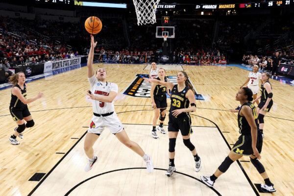 Mykasa Robinson #5 of the Louisville Cardinals drives to the basket against Emily Kiser #33 of the Michigan Wolverines during the first half in the Elite Eight round game of the 2022 NCAA Women's Basketball Tournament at Intrust Bank Arena, in Wichita, Kansas, on March 28, 2022. (Andy Lyons/Getty Images)