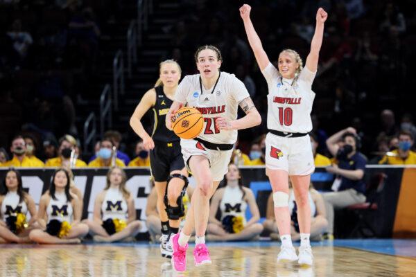 Emily Engstler #21 and Hailey Van Lith #10 of the Louisville Cardinals react during the final seconds of the second half in the Elite Eight round game of the 2022 NCAA Women's Basketball Tournament against the Michigan Wolverines at Intrust Bank Arena, in Wichita, Kansas, on March 28, 2022. (Andy Lyons/Getty Images)