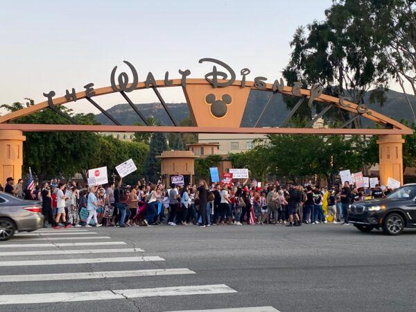 About 150 people attend a rally to oppose The Walt Disney Company's stance against a recently passed Florida law that prohibits schools from teaching their youngest students about sexual orientation and gender identity, outside of Disney's headquarters in Burbank, Calif., on April 6, 2022. (Jill McLaughlin/The Epoch Times)