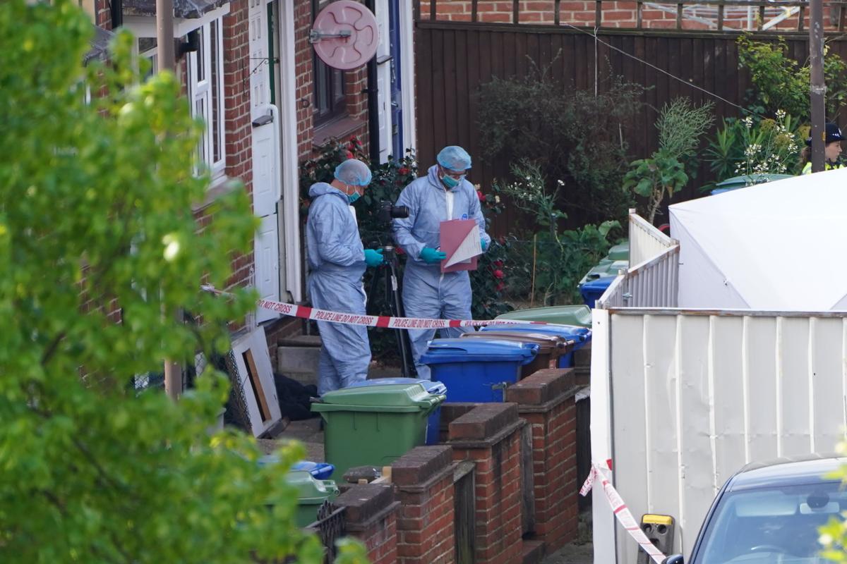 Police forensics officers outside the terraced house where the four family members who were stabbed to death, in Bermondsey, south-east London, on 26 April, 2022. (Kirsty O’Connor/PA)