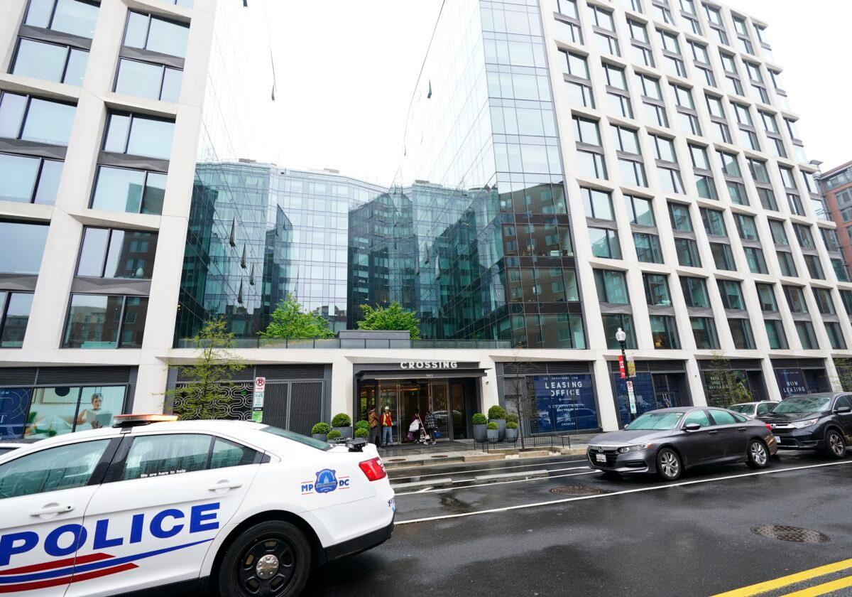 A Metropolitan Police patrol car is parked in front of a luxury apartment building where Arian Taherzadeh and Haider Ali were arrested for allegedly scheming to get close to Secret Service agents, in Washington on April 7, 2022. (Manuel Balce Ceneta/AP Photo)