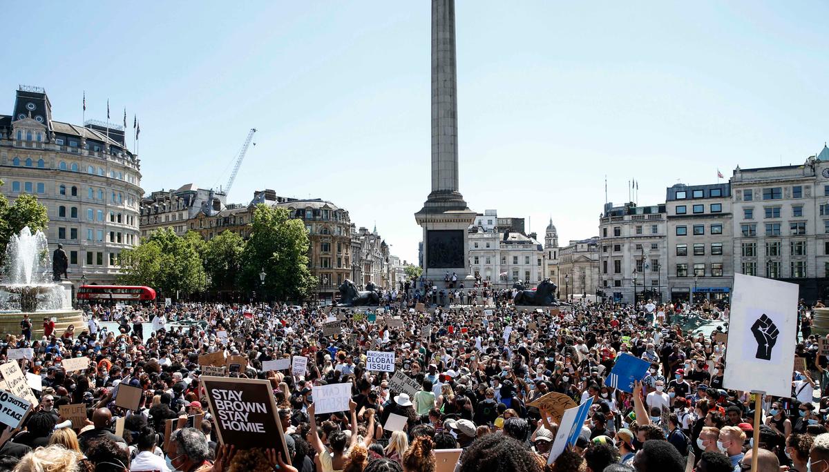 People hold placards as they join a march at Trafalgar Square in support of the demonstrations in America on May 31, 2020, in London, England. (Hollie Adams/Getty Images)