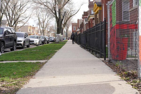 A seller walks on Patricia Carrillo's block in the West Humboldt Park neighborhood in Chicago on April 11, 2022. (Cara Ding/The Epoch Times)