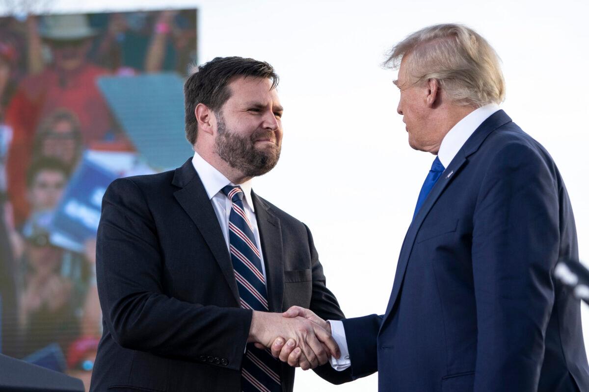 J.D. Vance (L), a Republican candidate for U.S. Senate in Ohio, shakes hands with former president Donald Trump during a rally at the Delaware County Fairgrounds in Ohio on April 23, 2022. (Drew Angerer/Getty Images)