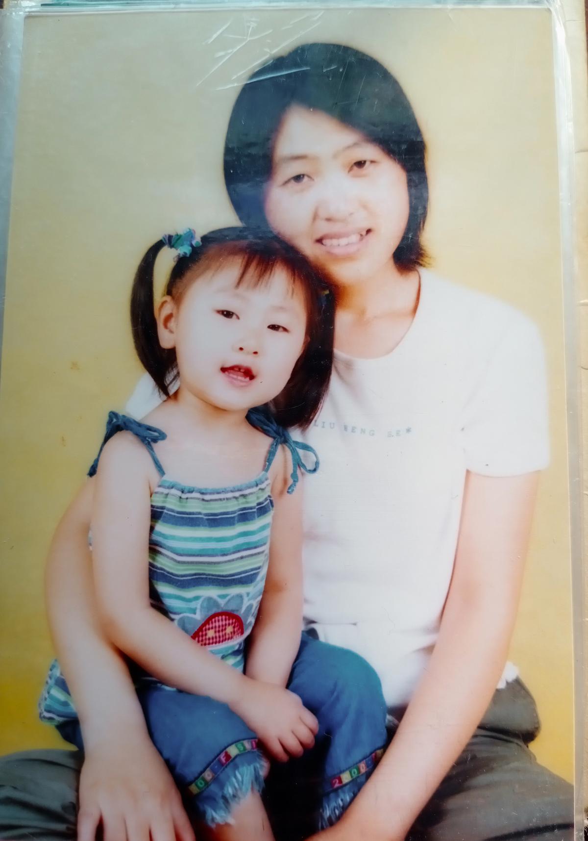 Zhang Minghui and her mother while her father was in detention, in Shandong Province, China, in 2000. (Courtesy of Zhang Minghui)