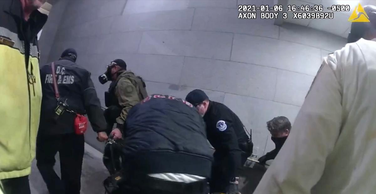 First responders pull Rosanne Boyland on a makeshift gurney to meet a transport unit from DC Fire and EMS at the U.S. Capitol on Jan. 6, 2021. (Metropolitan Police Department Bodycam/Screenshot via The Epoch Times)