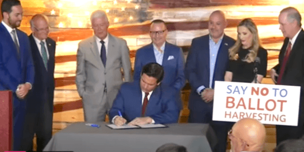 Florida Gov. Ron DeSantis signs a bill into law that establishes the nation's first Office of Election Crimes and Security at the Department of State specifically to investigate voter fraud at Spring Hills in Fla., on April 25, 2022. (Patricia Tolson/The Epoch Times)