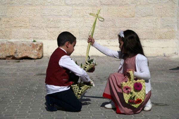 Palestinian Christian youth carry a cross as they attend Easter prayers at the Church of Saint Porphyrius in Gaza City, Palestine, on April 1, 2018. (Mohammed Abed/AFP via Getty Images)