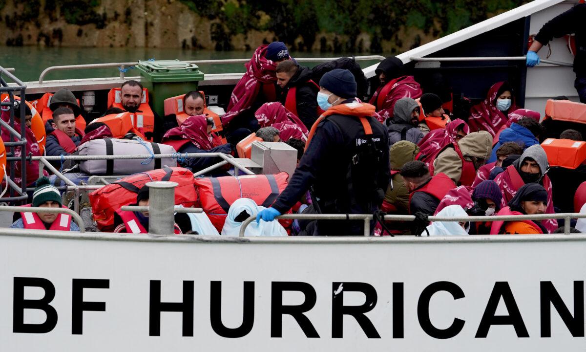 A group of people thought to be illegal immigrants onboard a Border Force vessel are brought in to Dover, Kent, England, on May 2, 2022. (Gareth Fuller/PA Media)