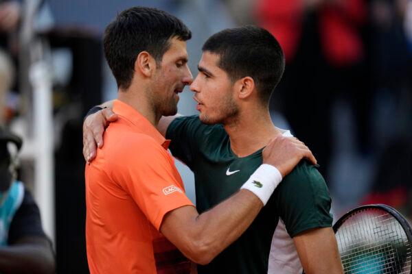 Novak Djokovic (L) shakes hands with Carlos Alcaraz at the end of a men's semifinal at the Mutua Madrid Open tennis tournament in Madrid, Spain, May 7, 2022. (Manu Fernandez/AP Photo)