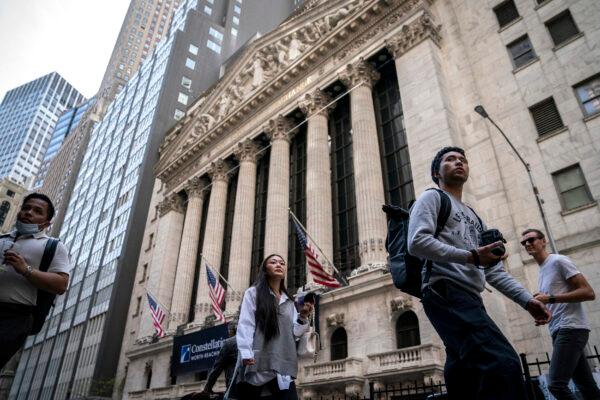 Pedestrians pass the New York Stock Exchange on May 5, 2022. (John Minchillo/AP Photo)