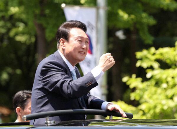 South Korea's new President Yoon Suk-yeol waves to his supporters while leaving after attending his inauguration ceremony at the National Assembly in Seoul, South Korea, on May 10, 2022. (Yonhap via Reuters)