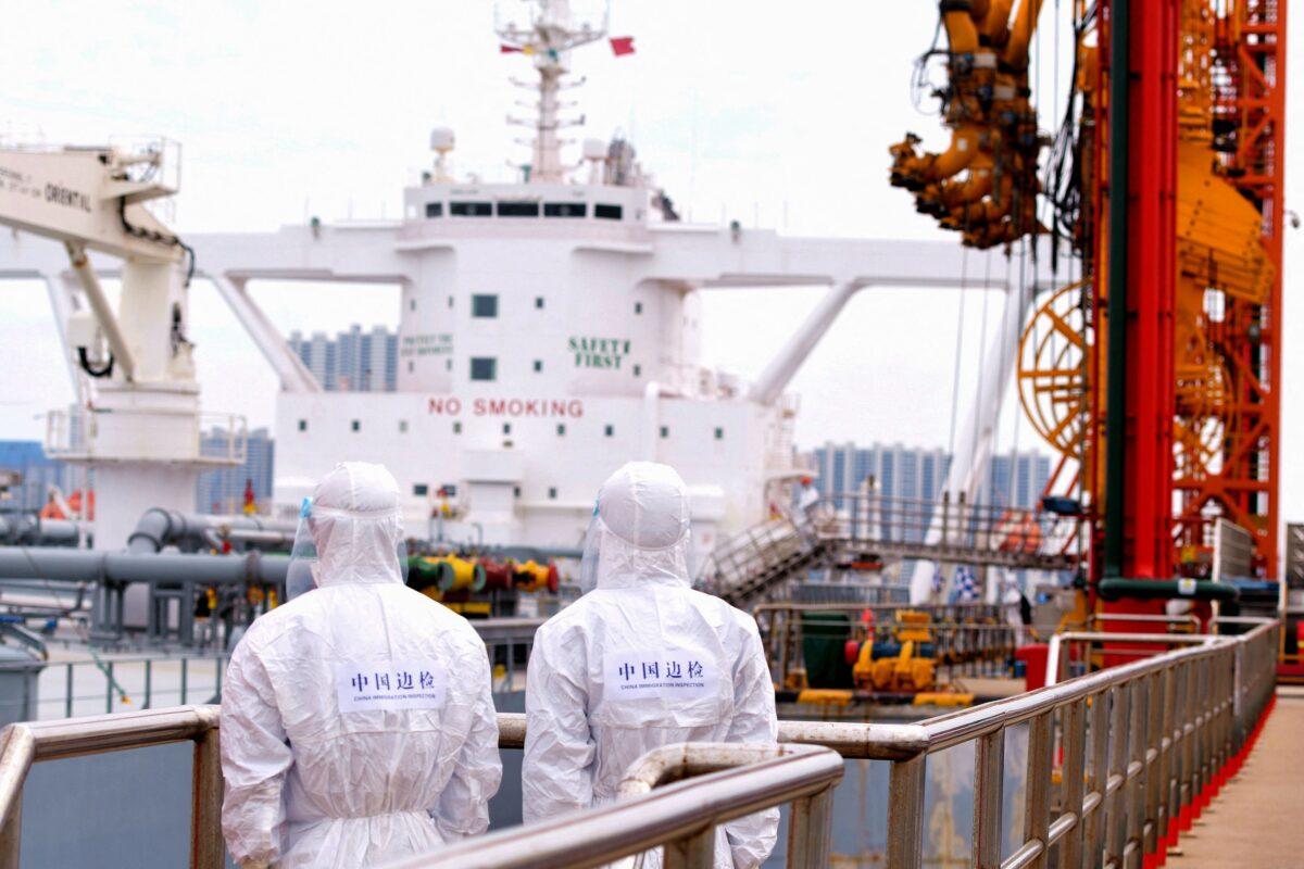 Immigration inspection officers check an oil tanker carrying imported crude oil at Qingdao port in China's Shandong Province on May 9, 2022. (STR/AFP via Getty Images)