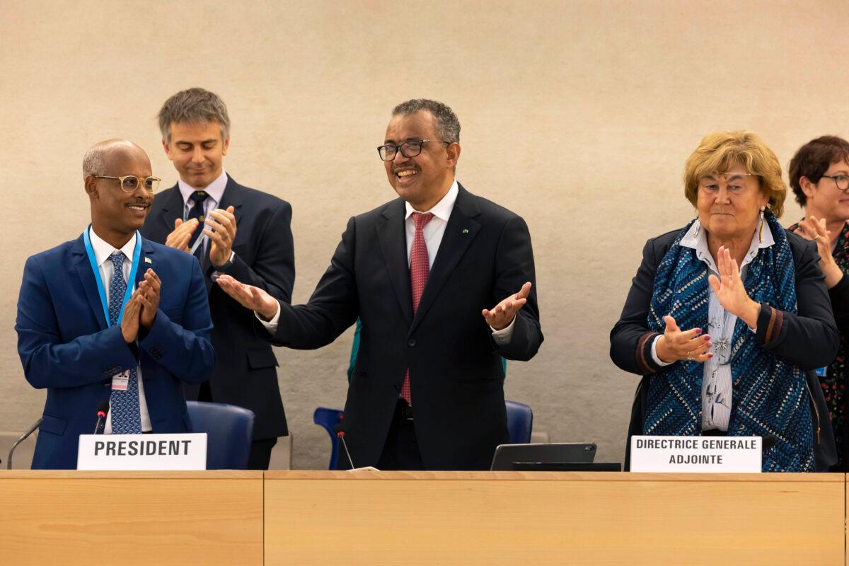 Tedros Adhanom Ghebreyesus, Director General of the World Health Organization (C), celebrates his reelection during the 75th World Health Assembly at the European headquarters of the United Nations in Geneva on May 24, 2022. (Salvatore Di Nolfi/Keystone via AP)