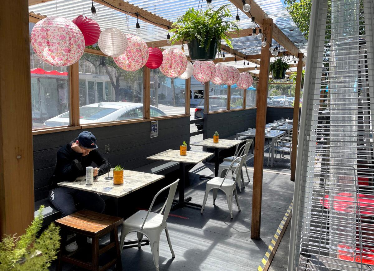 A lone customer sits in outdoor seating at a restaurant in San Francisco, Calif., on May 11, 2022. (Justin Sullivan/Getty Images)