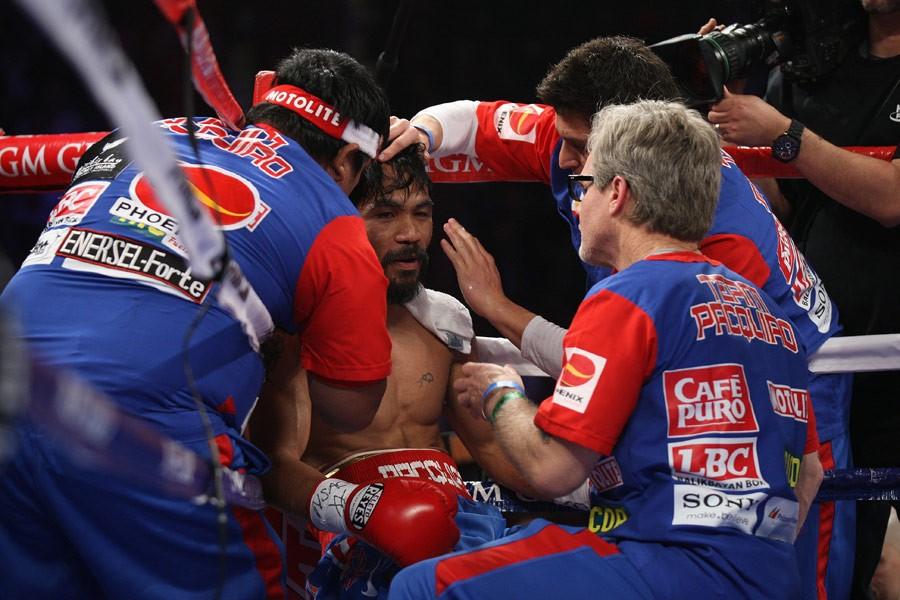 Manny Pacquiao (center) being tended to by his corner team, including trainer Freddie Roach (R) in "Manny." (Gravitas Ventures/Universal Pictures)