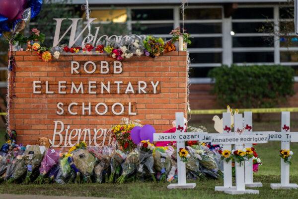 A memorial is seen surrounding the Robb Elementary School sign following the mass shooting at Robb Elementary School in Uvalde, Texas, on May 26, 2022. (Brandon Bell/Getty Images)