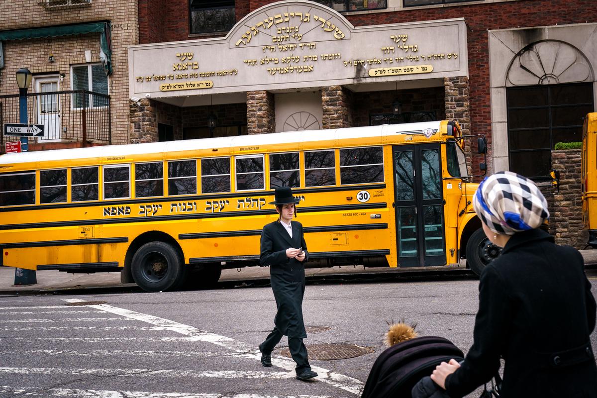 Pedestrians walk past the Yeshiva Kehilath Yakov School in the South Williamsburg neighborhood in the Brooklyn borough of New York City on April 9, 2019. (Drew Angerer/Getty Images)