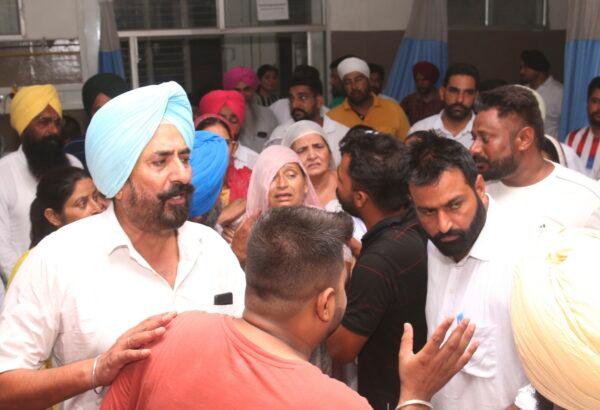 Mother (C), relatives, and friends of Shubhdeep Singh Sidhu, also known around the world by his stage name Sidhu Moose Wala, arrive at a hospital after he was shot in Mansa, Punjab state, India, on May 29, 2022. (AP Photo)