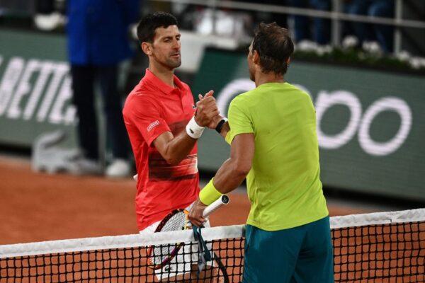 Spain's Rafael Nadal (R) shakes hands with Serbia's Novak Djokovic after winning at the end of their men's singles match on day ten of the Roland-Garros Open tennis tournament at the Court Philippe-Chatrier in Paris, France, on June 1, 2022. (Christophe Archambault/AFP via Getty Images)