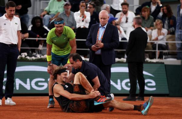 Rafael Nadal of Spain checks on Alexander Zverev of Germany as he receives medical attention following an injury during the Men's Singles Semi-Final match on Day 13 of The 2022 French Open at Roland Garros in Paris, France, on June 3, 2022. (Clive Brunskill/Getty Images)