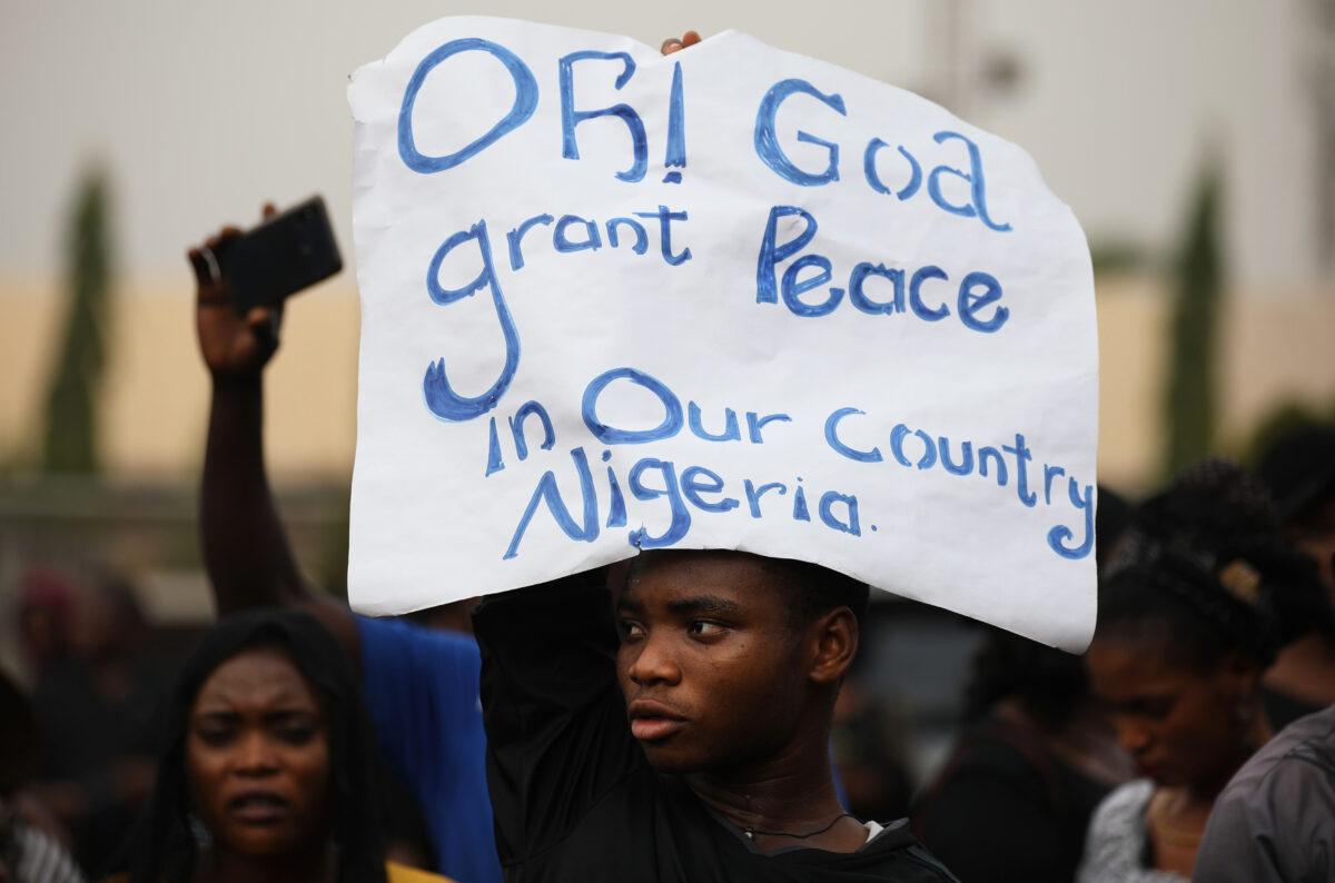 Christians faithfuls hold signs as they march on the streets of Abuja during a prayer and penance for peace and security in Nigeria in Abuja on March 1, 2020. (Kola Sulaimon/AFP via Getty Images)