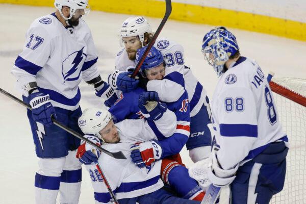 New York Rangers center Kevin Rooney (17) fights with Tampa Bay Lightning defenseman Mikhail Sergachev (98) and left wing Brandon Hagel (38) during the third period in Game 5 of the NHL Hockey Stanley Cup playoffs Eastern Conference Finals in New York, on June 9, 2022. (Adam Hunger/AP Photo)