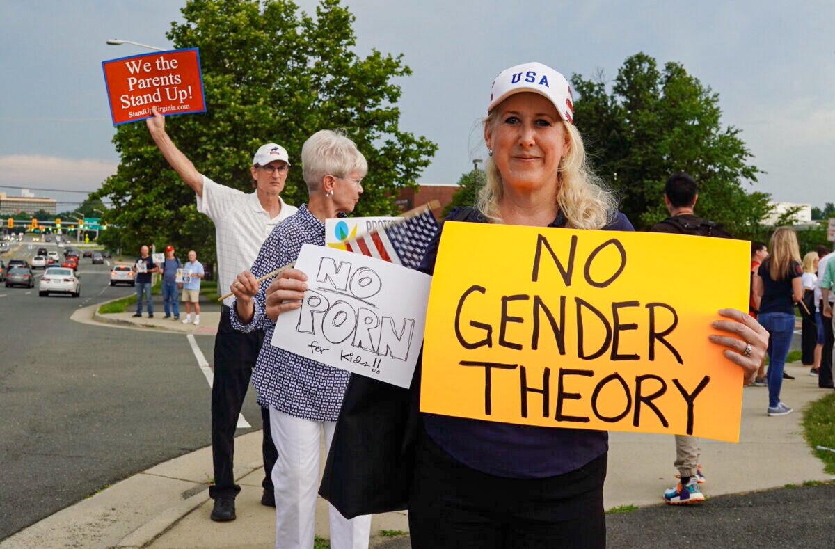 People protest a school board’s pro-transgender policy outside of a middle school in Falls Church, Va., on June 16, 2022. (Terri Wu/The Epoch Times)