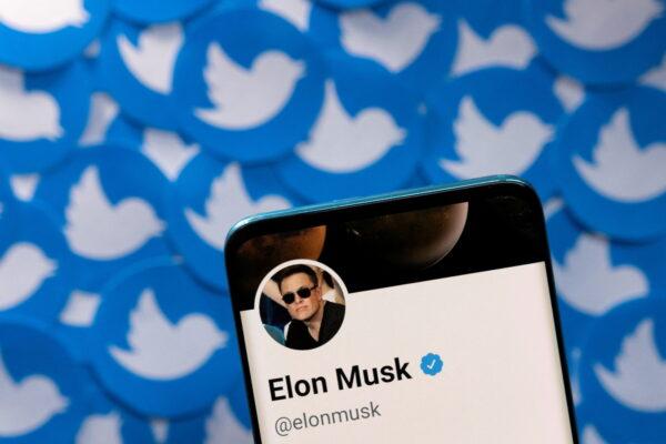 Elon Musk's Twitter profile on a smartphone placed on printed Twitter logos in this picture illustration taken on April 28, 2022. (Dado Ruvic/Reuters)