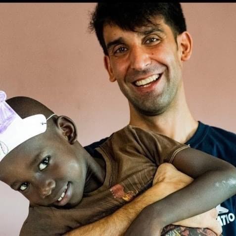 Matthew Perna holds the little boy he met during a mission trip to Haiti. At first, the boy would not smile or talk. They bonded, and a week later he was attached to Matthew. (Courtesy of Matthew's aunt, Geri Perna)