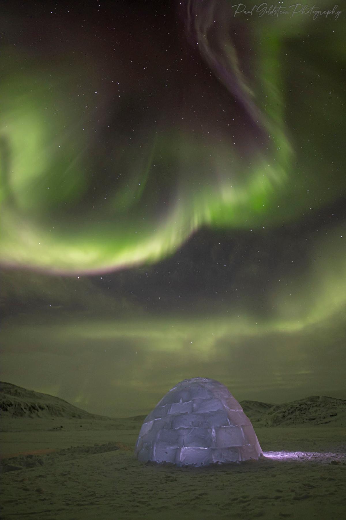 Northern lights dancing above an igloo in Nunavut, Canada. (Courtesy ofPaul Goldstein)