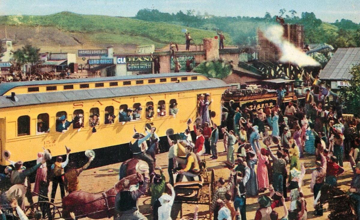 Photo postcard with a scene from the filming of "The Harvey Girls" (1946). This scene includes a Santa Fe train circa 1890s. (Public Domain)