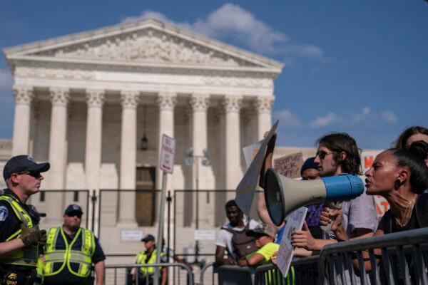 Pro-abortion activists (R) argue with pro-life activists in front of the Supreme Court in Washington on June 26, 2022. (Nathan Howard/Getty Images)