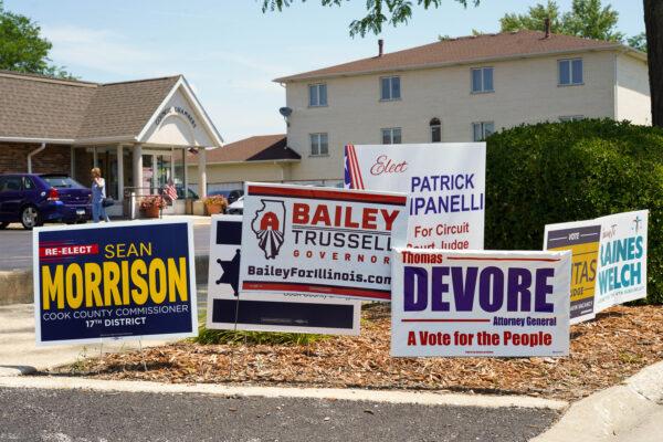 Campaign signs are seen outside of a polling location in Palos Hills, IL on primary day on June 28, 2022. (Cara Ding/The Epoch Times)